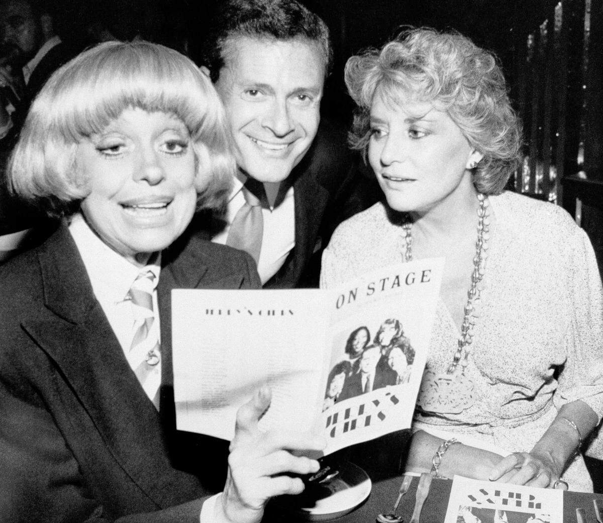 In this Sept. 1, 1981, file photo, Carol Channing, left, and television personality Barbara Walters look over the program with composer-lyricist Jerry Herman at a Broadway theater.