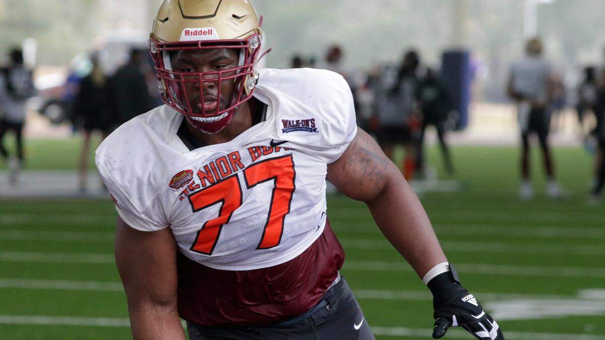 National Team offensive lineman Zion Johnson of Boston College (77) runs through drills during practice for the Senior Bowl NCAA college football game Thursday, Feb. 3, 2022, in Mobile, Ala. (AP Photo/Butch Dill)