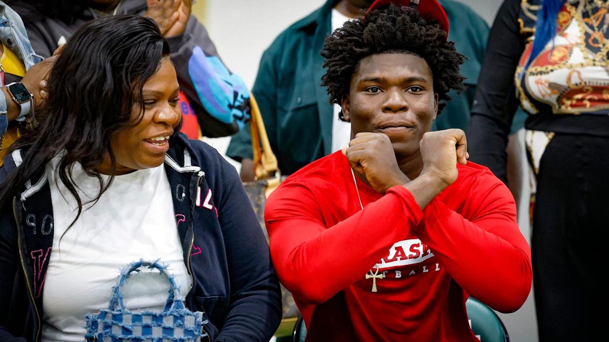 With family and mom Shakinah Hemingway by his side, Miami Central High School linebacker Vincent Shavers commits to Nebraska during the signing ceremony in Miami, Florida on Wednesday, December 20, 2023.