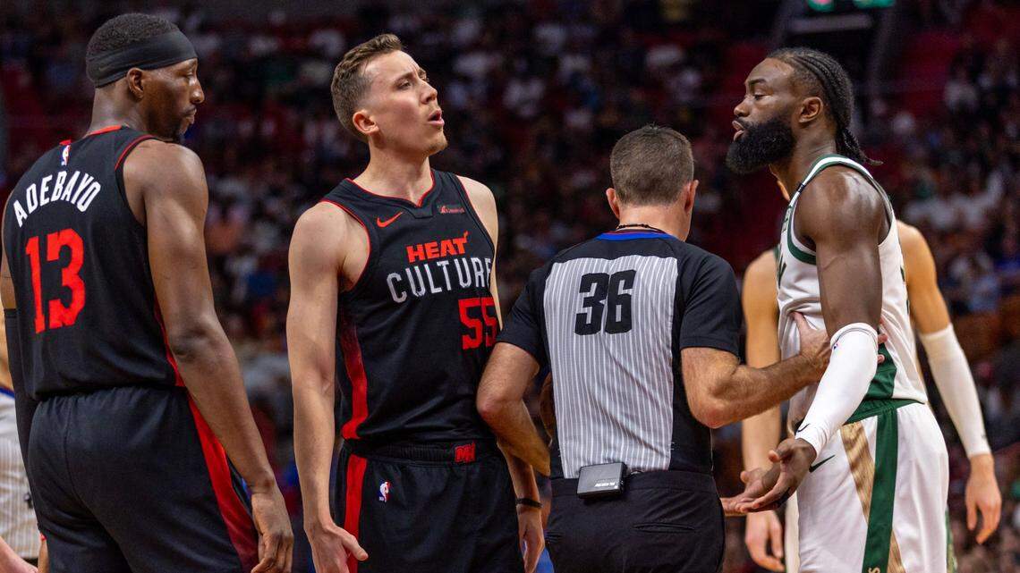 Miami Heat forward Duncan Robinson (55) interacts with Boston Celtics guard Jaylen Brown (7) after Brown was given a technical foul for pulling Robinson to the ground during the second half of an NBA game at Kaseya Center in Miami on February 11, 2024.