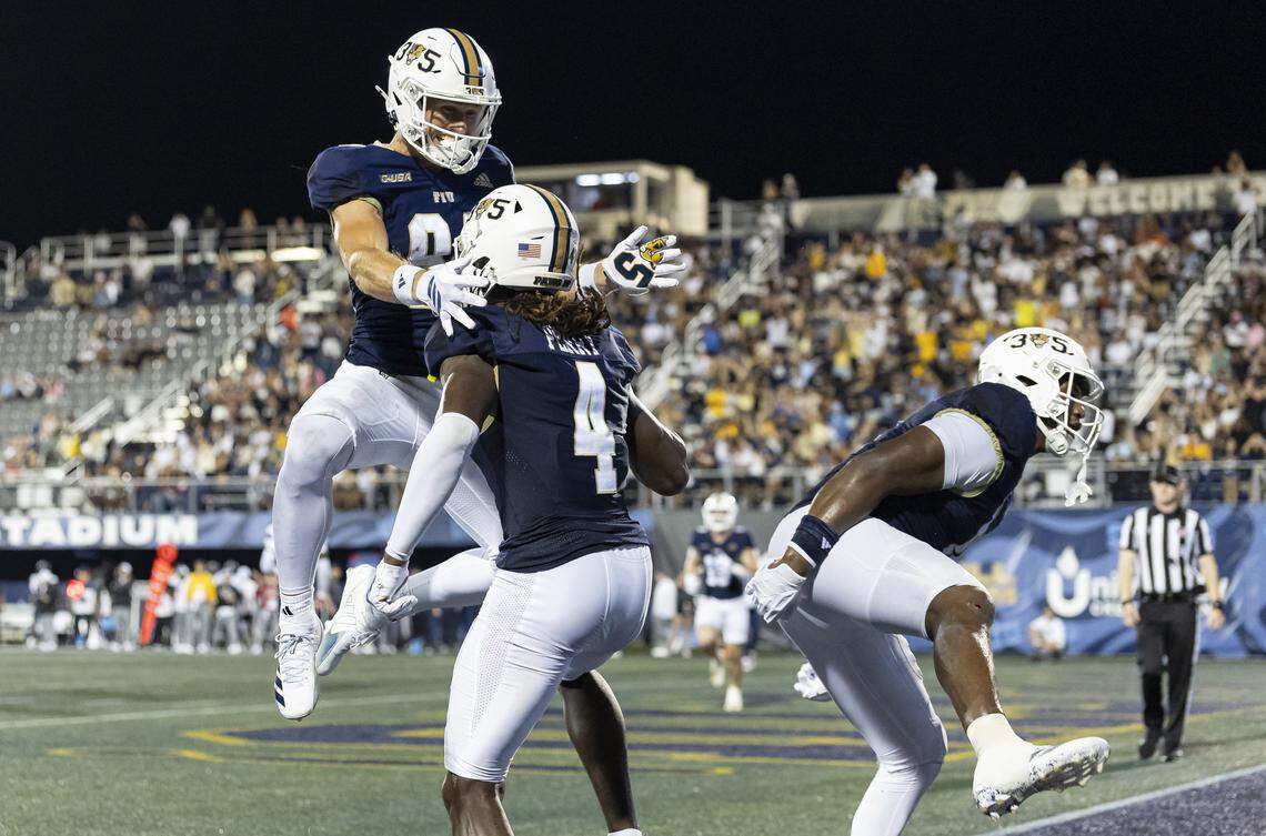 FIU Panthers wide receivers Alex Perry (4) and Maguire Anderson (84) celebrate after scoring against Florida Atlantic University Owls in the second half of their Shula Bowl football game at Pitbull Stadium on Saturday, Sept. 13, 2025, in Miami, Fla.