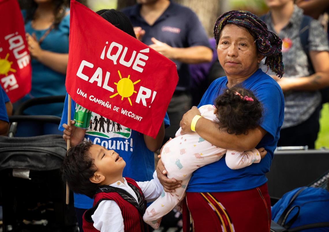 Lucia Quiej, center, field worker since 1993, attends a “¡Qué Calor!” rally by WeCount with her grandchildren calling for better working conditioning for outdoor workers before a Miami-Dade county commission Community Health Committee meeting on Monday, Sept. 11, 2023, at Government Center in Miami. The committee was voting on a bill called the Miami-Dade Heat standard for outdoor workers that would would create protections for outdoor workers on hot days like water, shade, and breaks. Quiej wants her grandchildren to remember the importance of community and standing up for what is right.