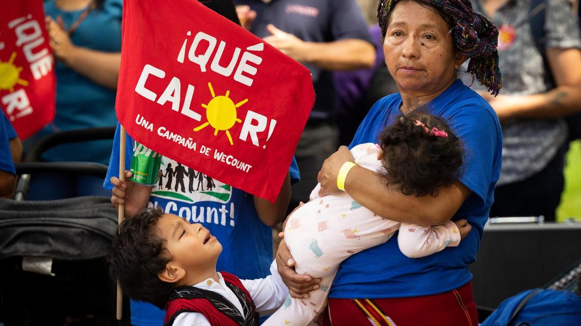 Lucia Quiej, center, field worker since 1993, attends a “¡Qué Calor!” rally by WeCount with her grandchildren calling for better working conditioning for outdoor workers before a Miami-Dade county commission Community Health Committee meeting on Monday, Sept. 11, 2023, at Government Center in Miami. The committee was voting on a bill cthat would would require employers to give their workers water and shaded breaks on hot days. Quiej took her grandchildren out of school to see the meeting to teach them the importance of community and standing up for what is right.