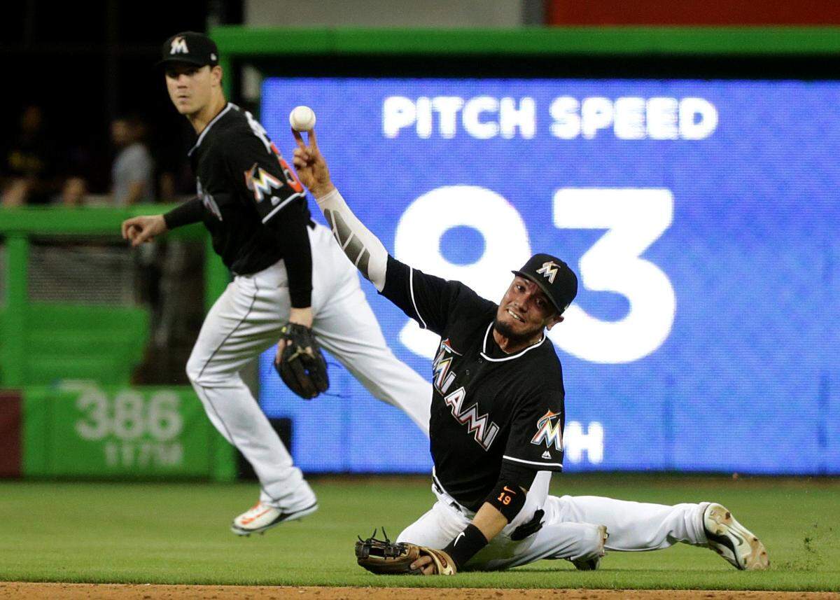 Marlins right fielder Brian Anderson backs up short stop Miguel Rojas as he throws to first base in the eight inning of the Miami Marlins vs Washington Nationals game at Marlins Park, Friday, May 25, 2018.
