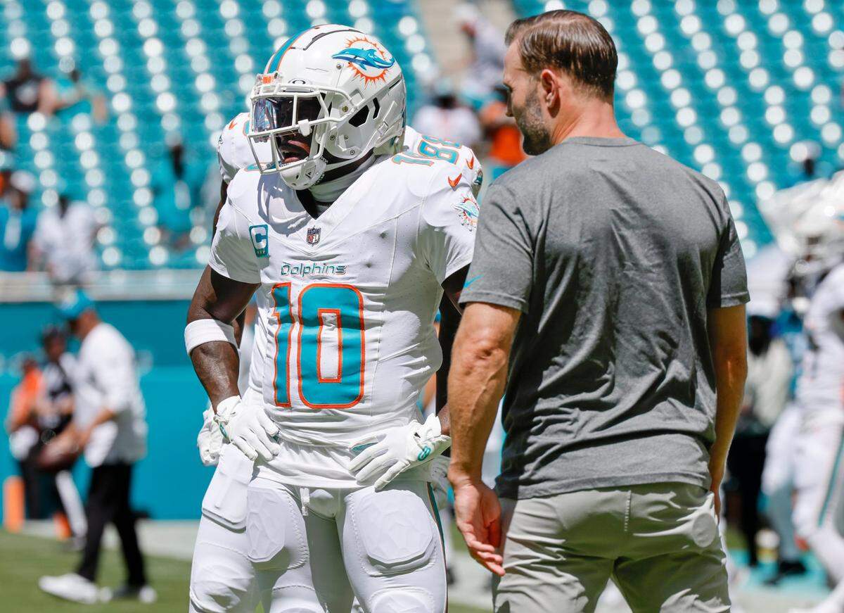 Miami Dolphins wide receivers coach Wes Welker talks to Dolphins wide receiver Tyreek Hill duringwarm ups before the start of the game against the Jacksonville Jaguars