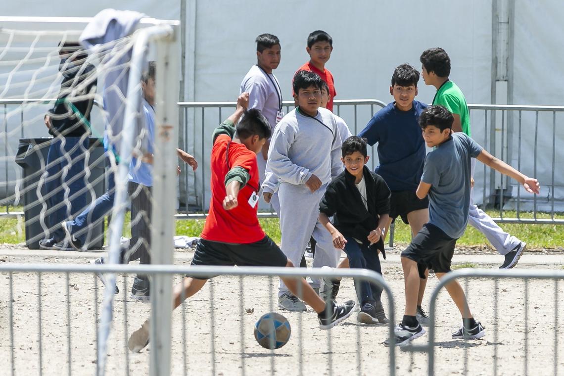Migrant children play soccer inside the Homestead Temporary Shelter for Unaccompanied Children during Good Friday in Homestead, Florida on April 19, 2019.