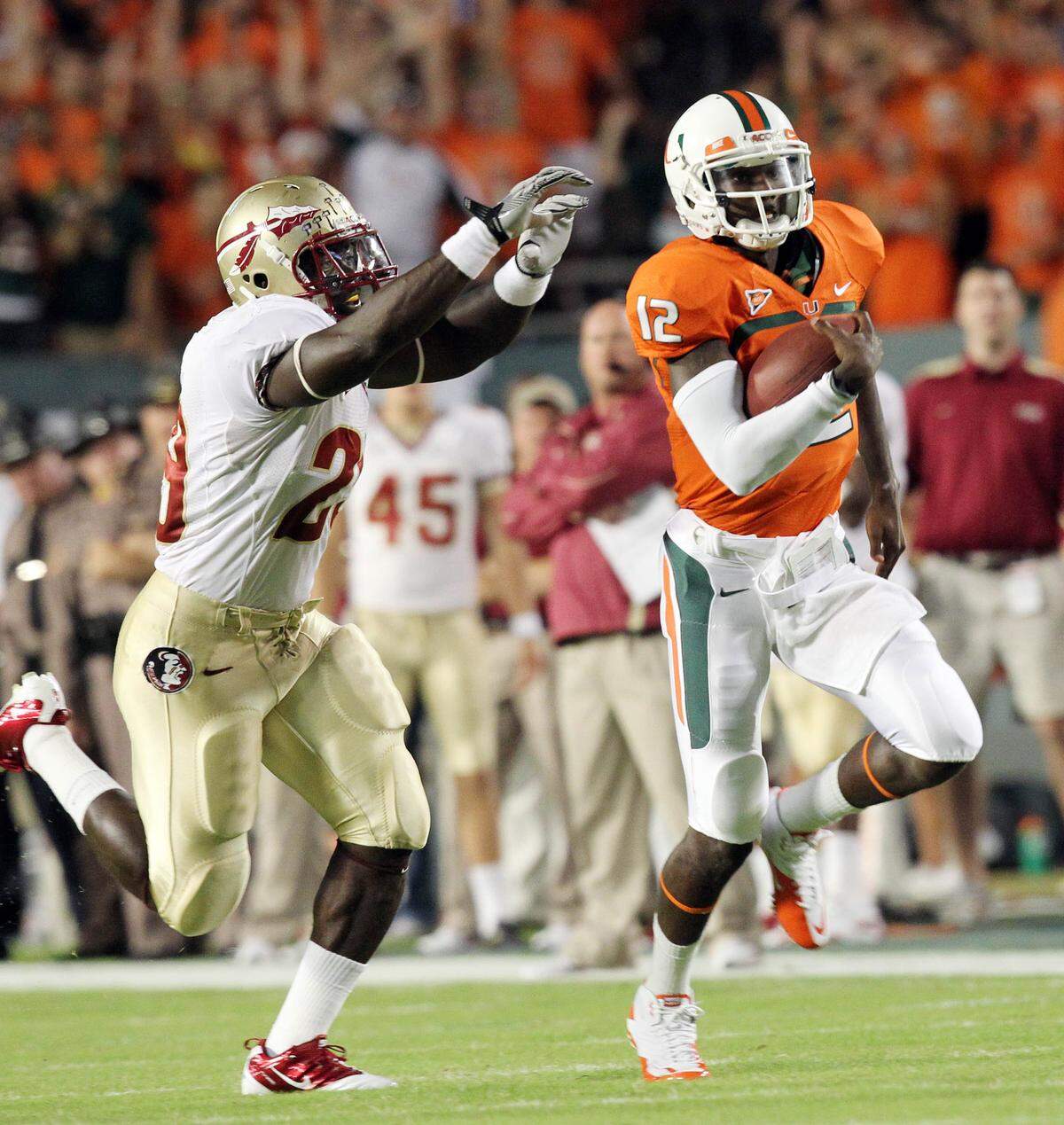 UM quarterback Jacory Harris runs for a first down in the first quarter while FSU Kendal Smith tries to stop him during the game of the University of MIami and Florida State on Saturday Oct 9,2010 at Sun Life Stadium in MIami Gardens.