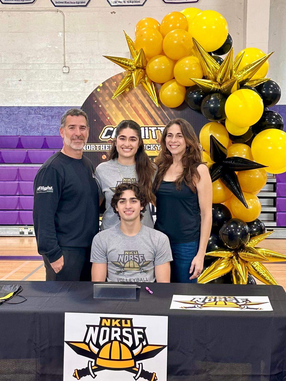 Southwest senior boys’ volleyball standout Juanmarco Diaz sits with his family around him after he signed his letter of intent to attend Northern Kentucky University.