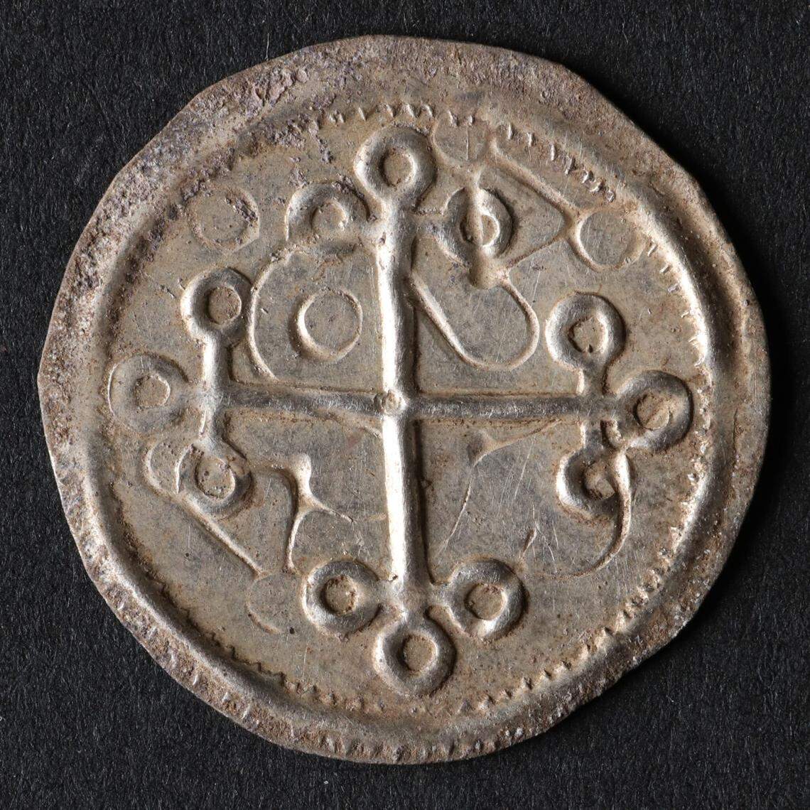 One of the Viking cross coins from the buried treasure troves.