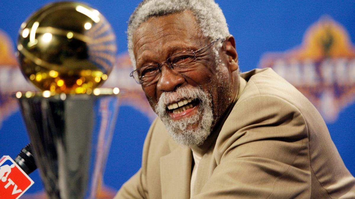 FILE - NBA great Bill Russell reacts at a as he learns the most valuable player award for the NBA basketball championships has been renamed the Bill Russell NBA Finals Most Valuable Player Award during a news conference Feb. 14, 2009 in Phoenix. Basketball fans hoping to buy something from Bill Russell’s memorabilia collection should expect some big-name competition. Hall of Famers Shaquille O’Neal and Charles Barkley say they’re interested in bidding on items that Russell — a civil rights icon and the most decorated champion in team sports history — is selling off. An online auction with 429 lots began last week and will culminate in a live event at the TD Garden on Friday, Dec. 10, 2021 (AP Photo/Matt York, File)
