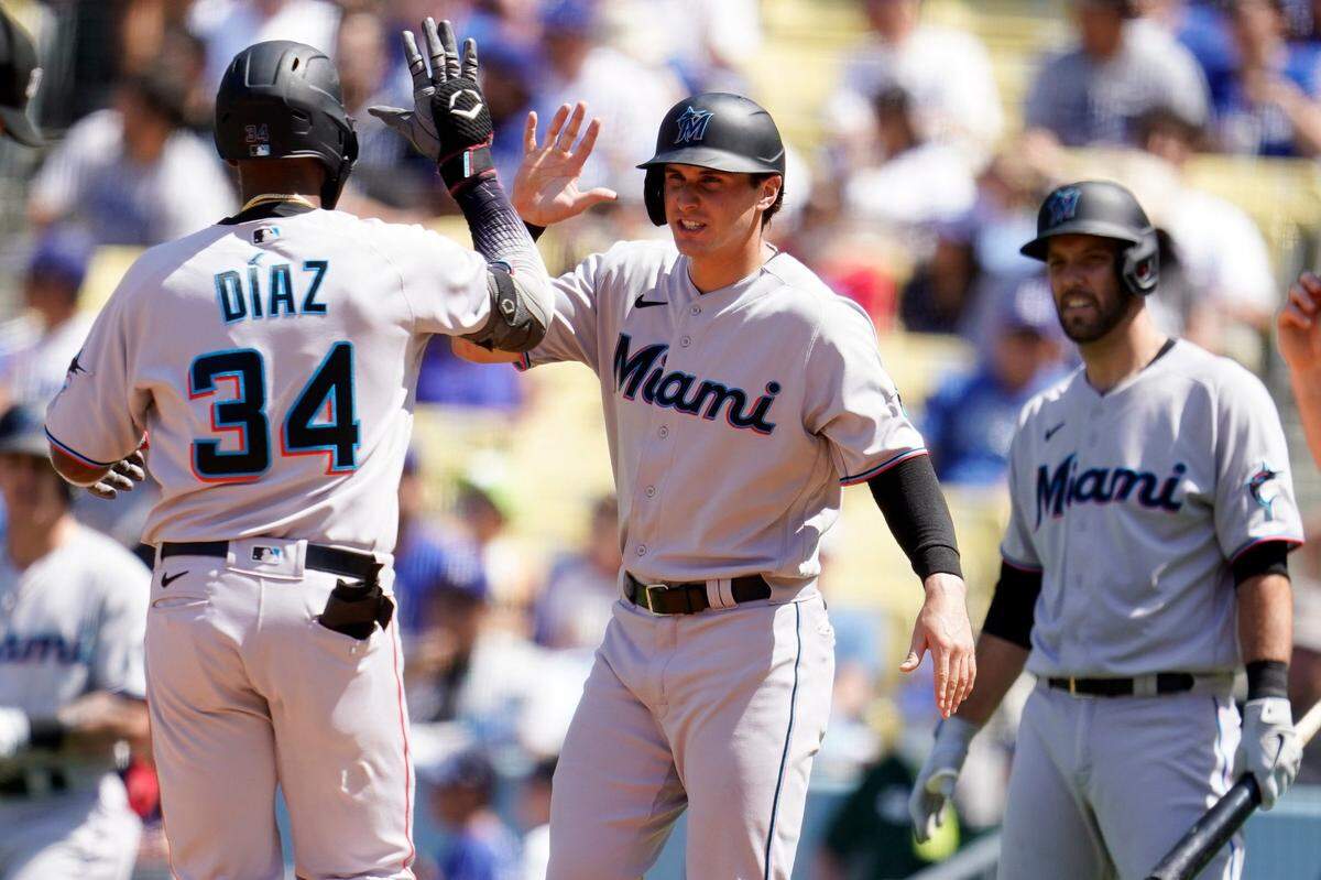 Miami Marlins’ Lewin Diaz (34) celebrates his two-run home run at home plate with JJ Bleday, center, during the fourth inning of a baseball game against the Los Angeles Dodgers, Sunday, Aug. 21, 2022, in Los Angeles. (AP Photo/Marcio Jose Sanchez)