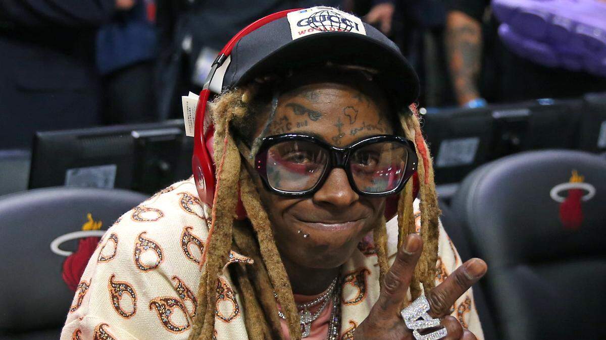 Rapper Lil Wayne pose for the picture after an NBA basketball regular season game between Los Angeles Lakers against the Miami Heat at the AmericanAirlines Arena on Friday, December 13, 2019 in Miami. Lakers won 113-110.