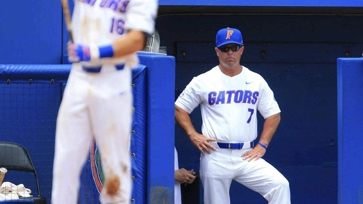 FILE - In this June 9, 2018, file photo, Florida head coach Kevin O’Sullivan stands in the dugout during the third inning of an NCAA Super Regional college baseball game against the Auburn, in Gainesville, Fla. O’Sullivan’s Gators hope their series win over rival Miami snaps them out of a funk that saw them get off to a 3-3 start, their worst since 2013.
