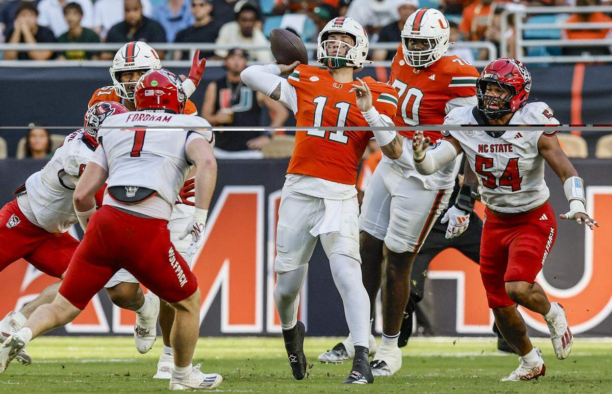 Miami Hurricanes quarterback Carson Beck (11) sets up to pass in the first half of an NCAA football game against the NC State Wolfpack at Hard Rock Stadium in Miami Gardens, Florida, on Saturday, November 15, 2025.