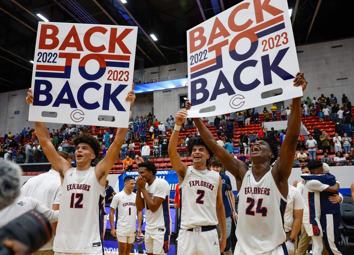 Columbus High School’s Cameron Boozer (12), Cayden Boozer (2), and Malik Abdullahi (24) celebrate their back to back State Titles during the FHSAA boys basketball Class 7A State Championship at the RP Funding Center in Lakeland, Florida on Saturday, March 4, 2023.