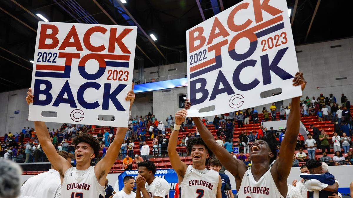 Columbus High School’s Cameron Boozer (12), Cayden Boozer (2), and Malik Abdullahi (24) celebrate their back to back State Titles during the FHSAA boys basketball Class 7A State Championship at the RP Funding Center in Lakeland, Florida on Saturday, March 4, 2023.