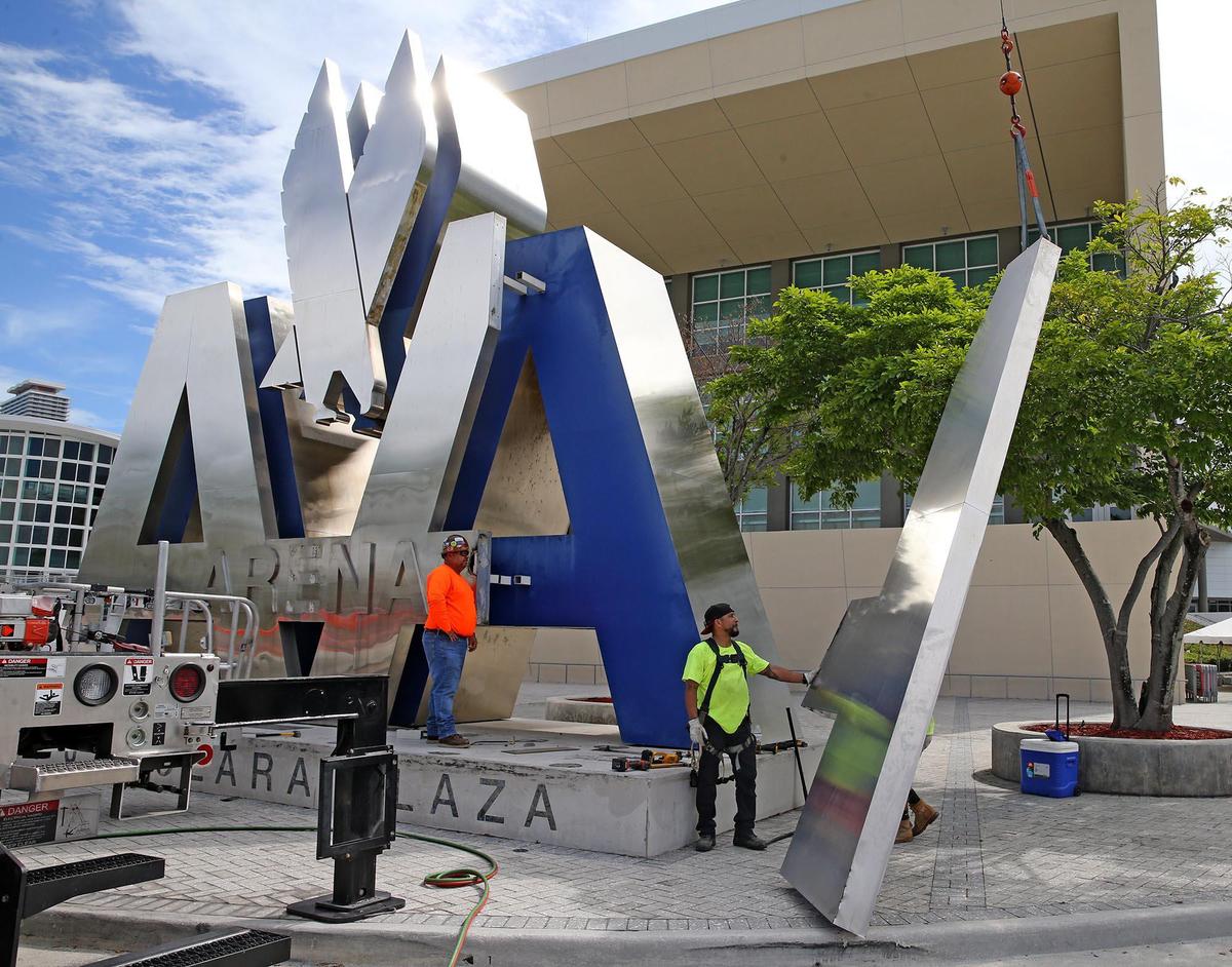 Workers remove one of the A’s from the Peter J. Dolara Plaza sculpture at the Miami Heat’s arena, June 1, 2021. American Airlines Arena letters were removed from the Miami Heat’s arena as the branding changes from American Airlines Arena to the FTX Arena.