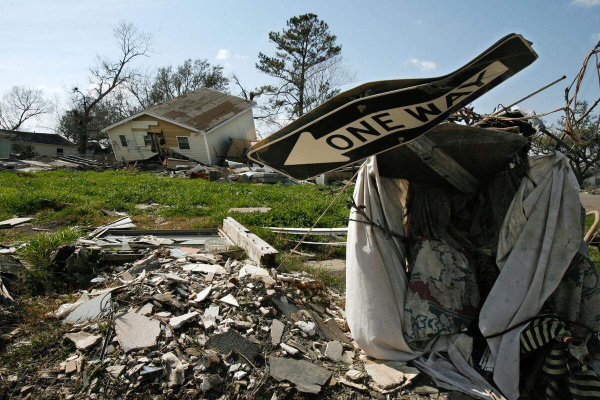 Street signs and houses knocked loose or destroyed by Hurricane Katrina in New Orleans' Ninth Ward.