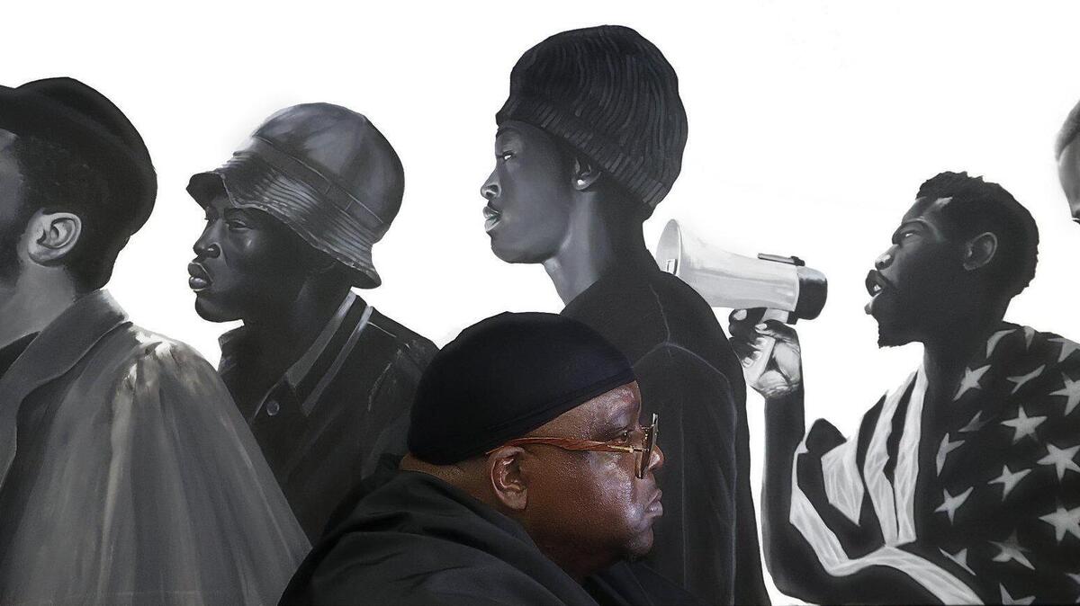 Muralist Addonis Parker, who opened his exhibit and Still We Rise in Opa-locka, is photographed among his artwork dealing with Black identity, liberation, and strength at his studio in Miami.