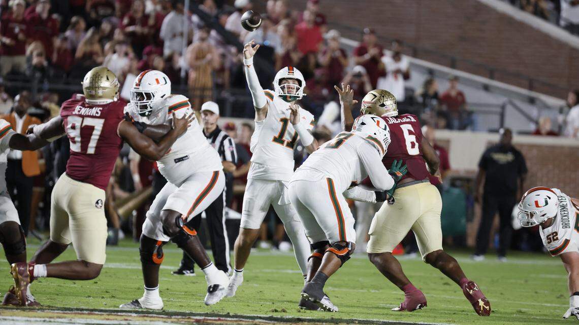 Miami Hurricanes quarterback Carson Beck (11) sets up to pass in the first half.