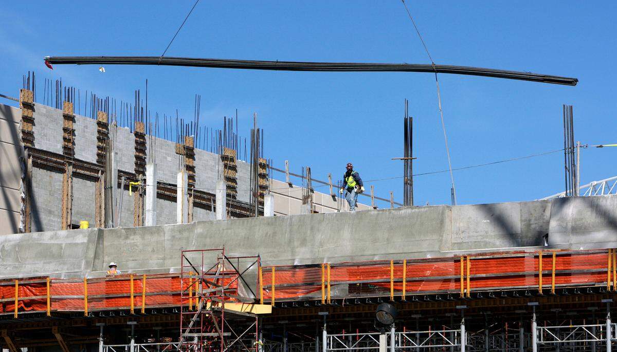 A worker watches a bundle of steel rebar during construction in 2008 for the MIA Mover station, which will connect Miami International Aiport to the Miami Intermodal Center — a transportation hub where Metrorail, Tri-Rail, Amtrak, local buses and taxis will converge, just east of the airport.
