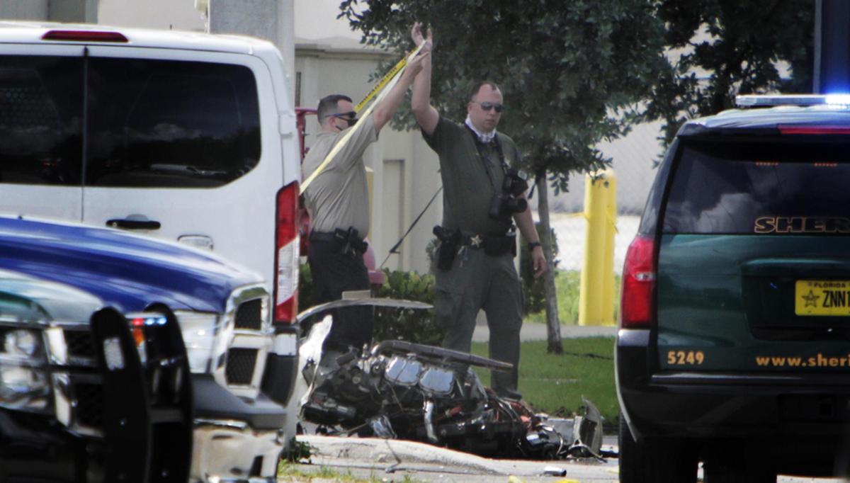 Miami, Florida, August 28, 2020- BSO investigators walk by one of the engines of a small aircraft that crashed early this morning in Broward County. Two people have died. 1824 S. Park Rd., Hallandale Beach