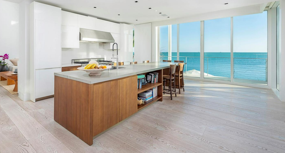 The house has floor to ceiling impact windows throughout every room and floor, including in the kitchen.