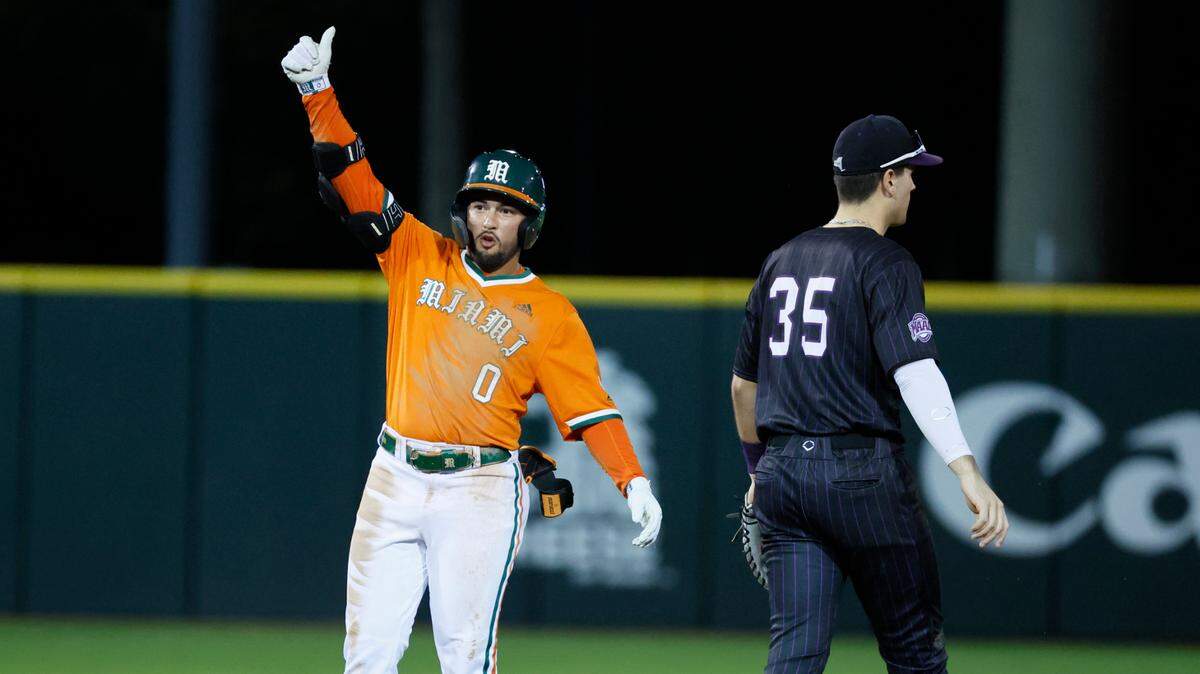 Miami Hurricanes infielder Dorian Gonzalez Jr. (0) reacts after a double as Niagara University Jason Green (35) walks away at Alex Rodriguez Park at Mark Light Field on the University of Miami Campus in Coral Gables, Florida on Friday, February 14, 2025.