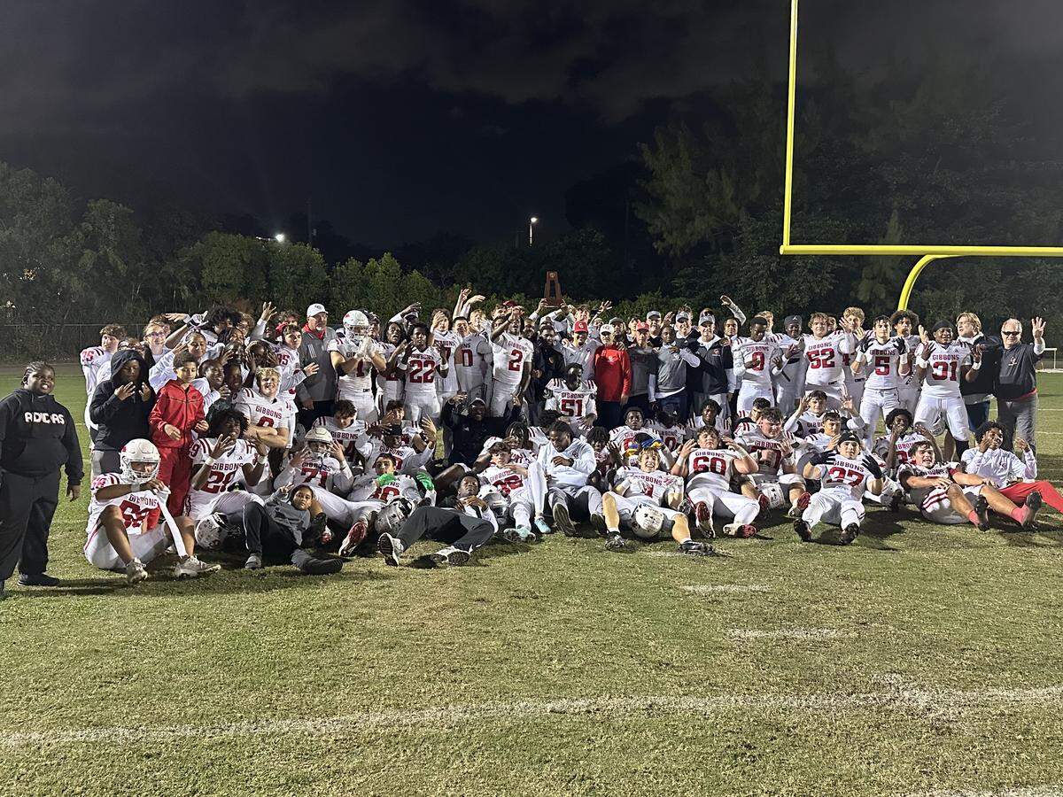 The Cardinal Gibbons football team gathers on the field after beating Immaculata-La Salle to win the Region 4-2A football championship on Friday at La Salle.