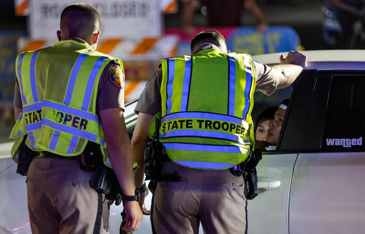 Florida Highway Patrol officers talk to a driver at a DUI checkpoint near 5th Street and Meridian during spring break on Friday, March 8, 2024, in Miami Beach, Fla.