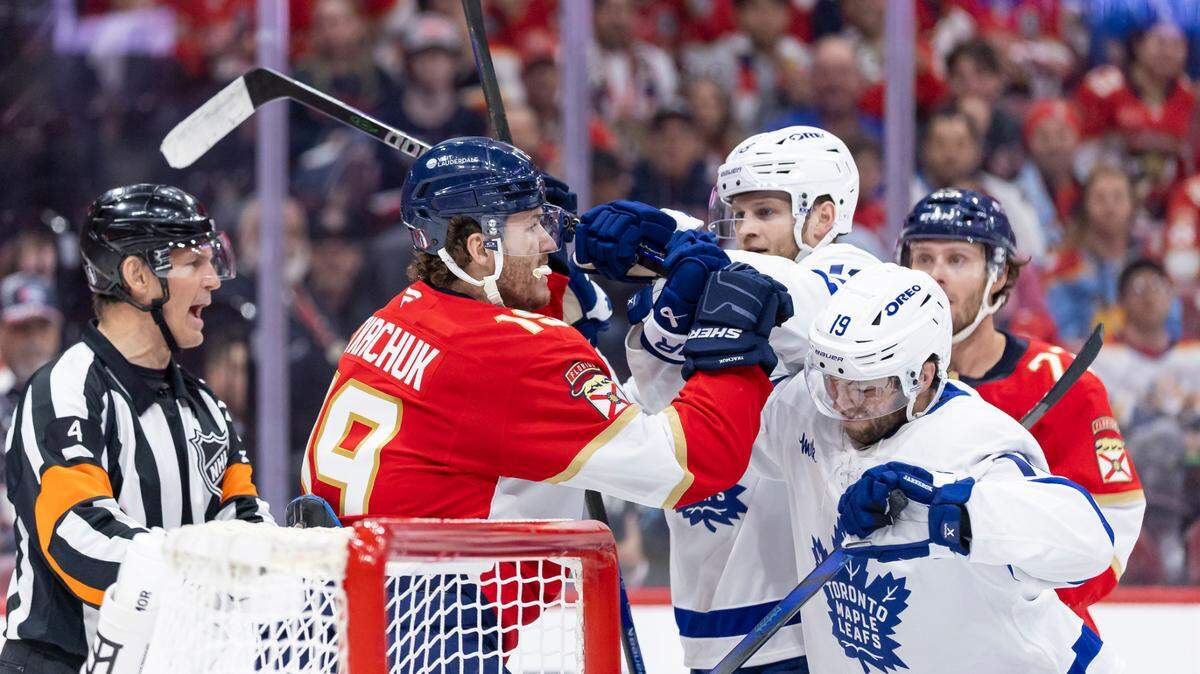 Toronto Maple Leafs center Steven Lorentz (18) pushes Florida Panthers left wing Matthew Tkachuk (19) in the third period of Game 3 of a second-round Stanley Cup playoffs series at the Amerant Bank Arena on Friday, May 9, 2025, in Sunrise, Fla.