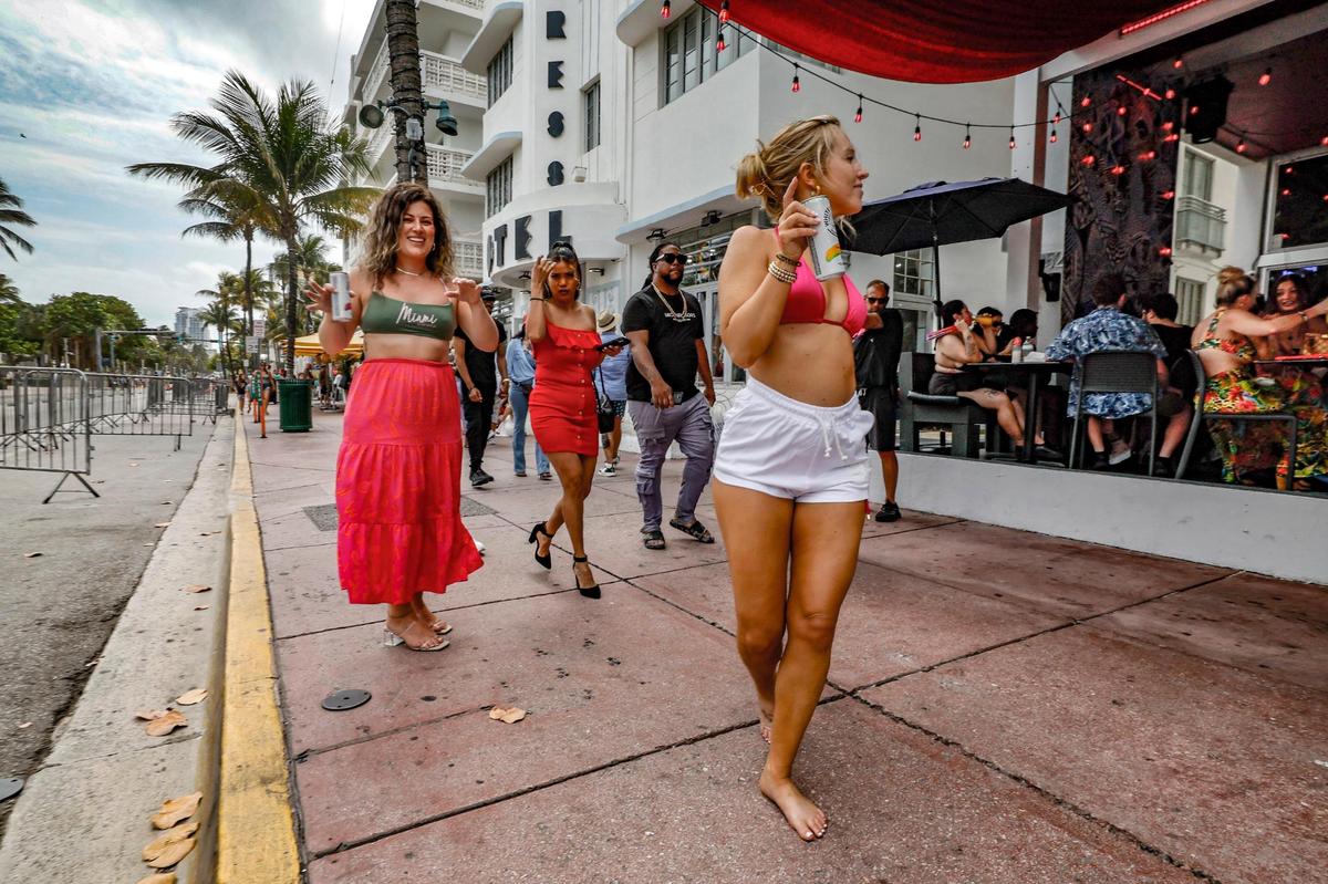 Madison Criswell dances in front of the Palace Bar on Ocean Drive during spring break on Miami Beach, Florida on Saturday, March 15, 2025.