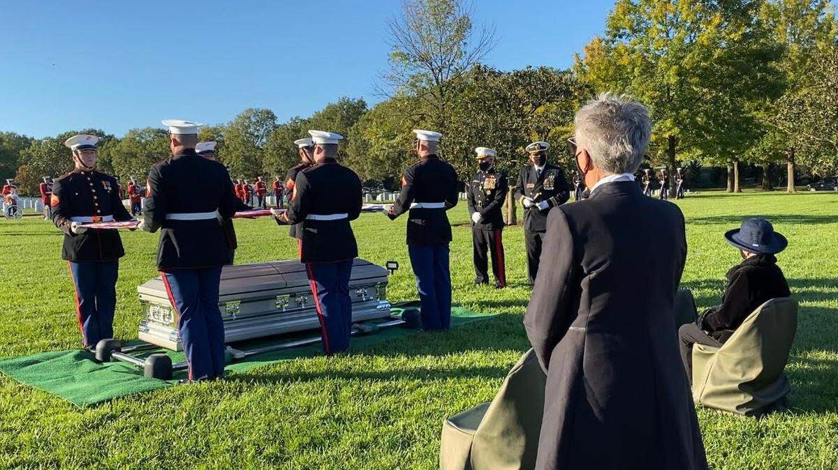Georgie Carter-Krell, seated at right, watches U.S. Marine Corps soldiers fold an American flag over the casket of her son, Marine Pvt. First Class Bruce W. Carter, whose remains were recently exhumed from a Miami cemetery and laid to rest on Nov. 4 at Arlington National Cemetery in Virginia.