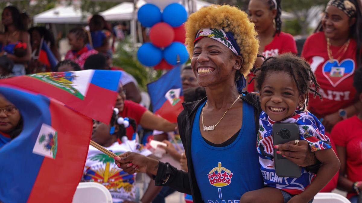 Cynthia Denesvar, 34, dances with her daughter, Joycelyn, 3, right, as South Florida’s Haitian community gathered at the Museum of Contemporary Art in North Miami to celebrate Haitian Flag Day during Haitian Heritage Month on Thursday, May 18, 2023.