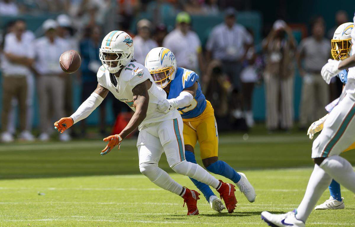 Los Angeles Chargers linebacker Junior Colson (25) holds Miami Dolphins wide receiver Jaylen Waddle (17) forcing him to miss a catch in the first half of their NFL game at Hard Rock Stadium on Sunday, Oct. 12, 2025, in Miami Gardens, Fla.