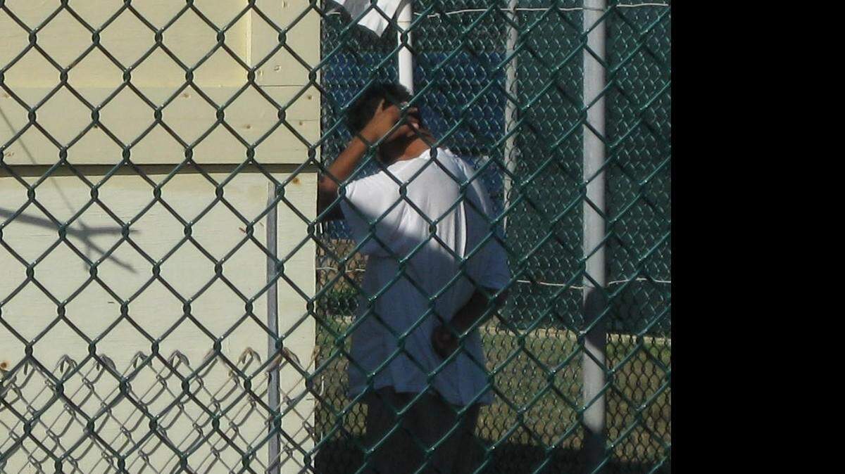 A Uighur captive from China, ordered released last year by a federal judge, walks away from the entrance to Camp Iguana in this Oct. 14, 2009 photo cleared for release by a Pentagon contractor at the U.S. Navy base at Guantanamo Bay, Cuba.
