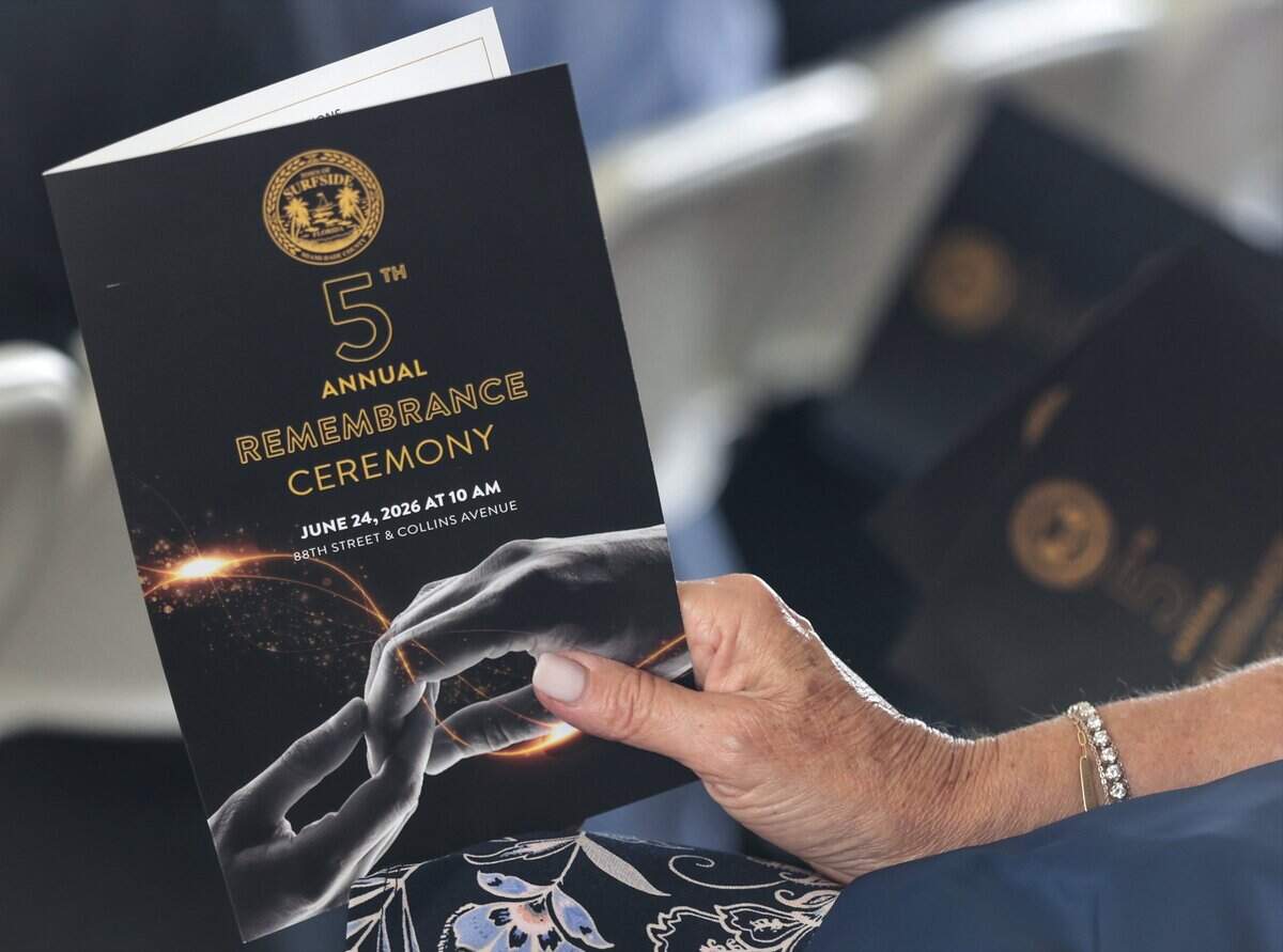 Attendees hold on to event programs as the Town of Surfside held its fifth annual Remembrance event on Wednesday, June 24, 2026, honoring the 98 people killed in the Champlain Towers South building collapse in Surfside, Florida.