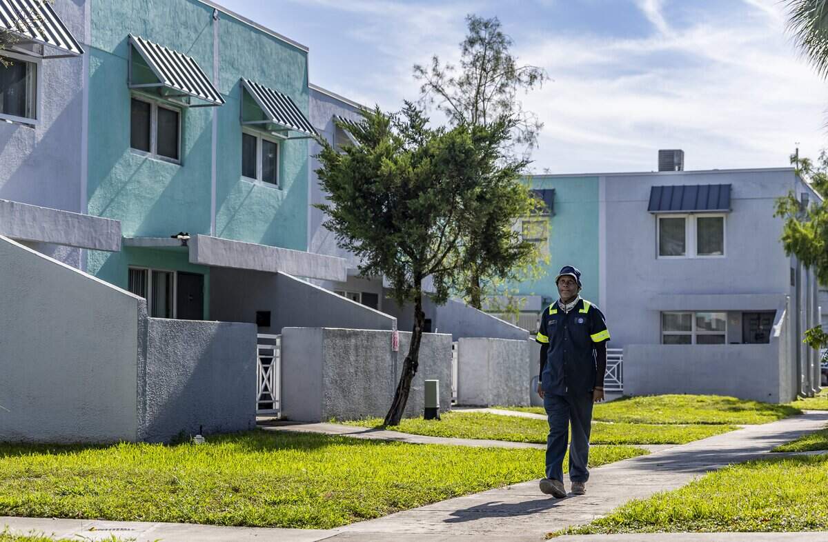 Ronnie McDonald, 62, a resident at Town Park Plaza South, walks through his neighborhood on Friday, May 8, 2026, in Miami, Fla. Residents of the Section 8 housing community in Overtown are currently living with leaks, mold, and damage inside their homes following a failed renovation project and the community has now filed a lawsuit against the design-builder/general contractor and its roofing subcontractor.