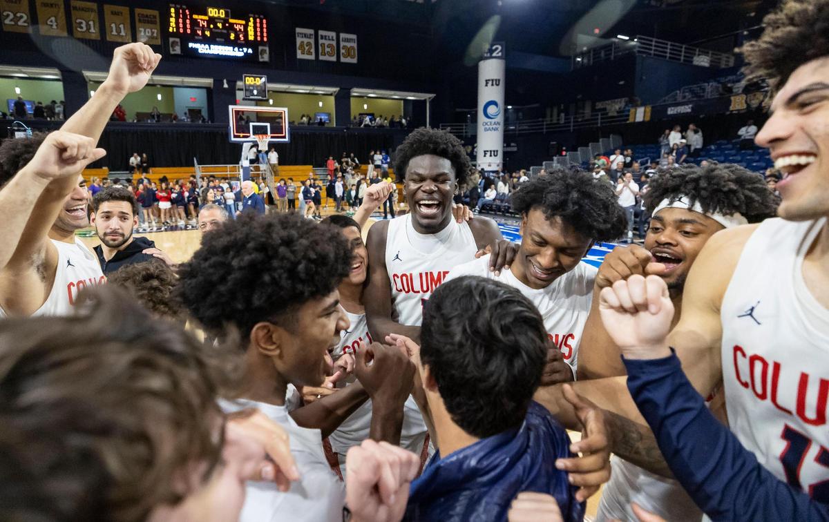 Columbus Explorers players celebrate after they defeated the Miami Stingarees in their Region 4-7A championship basketball game final at the Ocean Bank Convocation Center on Thursday, Feb. 20, 2025, in Miami, Fla.