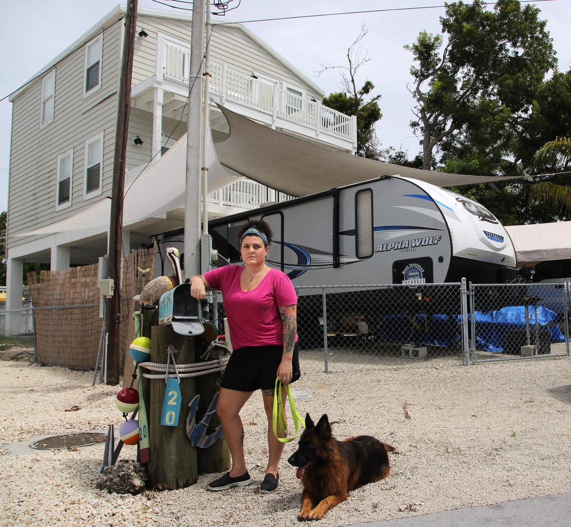 On Thursday, August 30, 2018 Key Largo resident Melinda Goodro and her wife, are having a tough time getting paid by Citizens Insurance after damages from Hurricane Irma nearly a year ago. Goodro stands at outside their home with her dog, “Qynn” where she is still living in her RV a year later. Her three-story home suffered heavy roof and water damage and repairs can not be made until insurance claim has been resolved. 