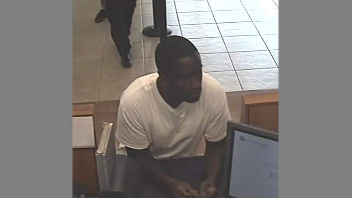 Sandy Graham at a Chase bank branch, at 4224 Hollywood Blvd., talking to a teller. The FBI said he robbed this bank then moved onto a nearby Bank of America.