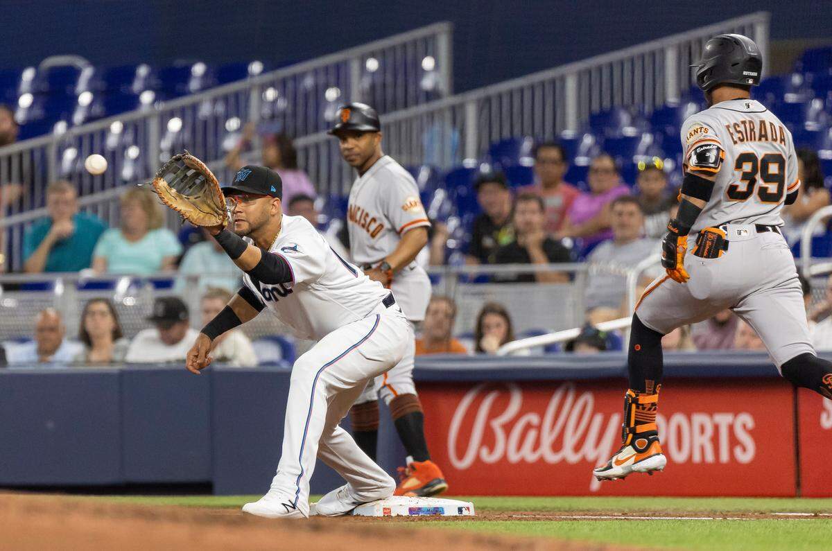Miami Marlins first baseman Yuli Gurriel (10) tags San Francisco Giants second baseman Thairo Estrada (39) out after he hit a ground ball to third base in the third inning of an MLB game at loanDepot park on Monday, April 17, 2023, in Miami, Fla.