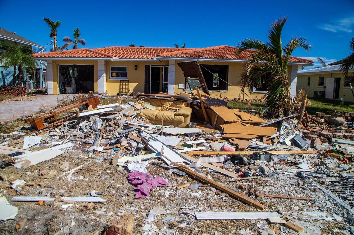 Debris from Hurricane Ian is strewn about the front yard of a Fort Myers Beach home Wednesday, Oct. 26, 2022, a month after the Category 4 storm hit the area.