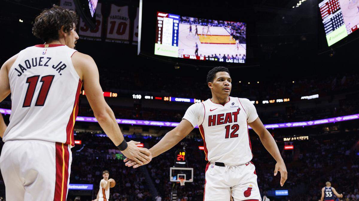 Miami Heat guard Dru Smith (12) high-fives forward Jaime Jaquez Jr. (11) during the first quarter of a game on Dec. 1, 2025, at Kaseya Center in Miami.