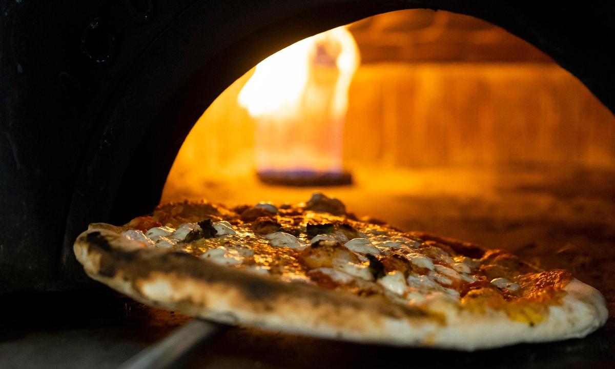 A Margherita pizza bakes at Napoli 1800 Cucina & Pizzeria in Kendall.