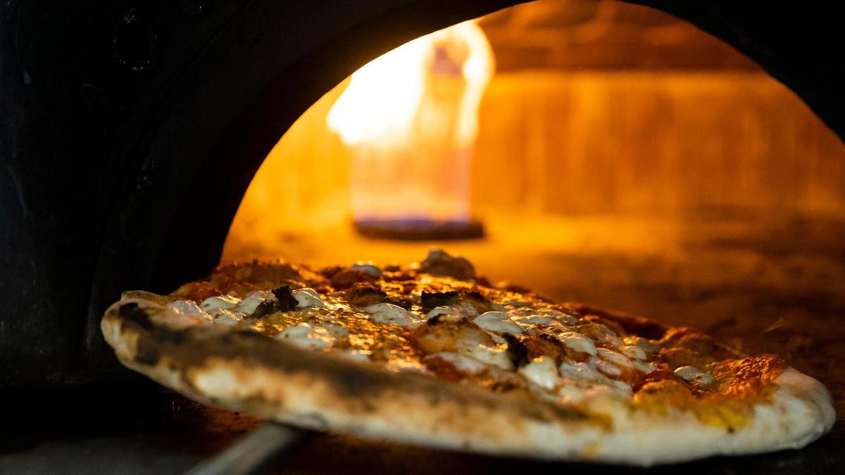 A margherita pizza is seen baking at Napoli 1800 Cucina & Pizzeria on Tuesday, Feb. 7, 2023, in Miami, Fla.