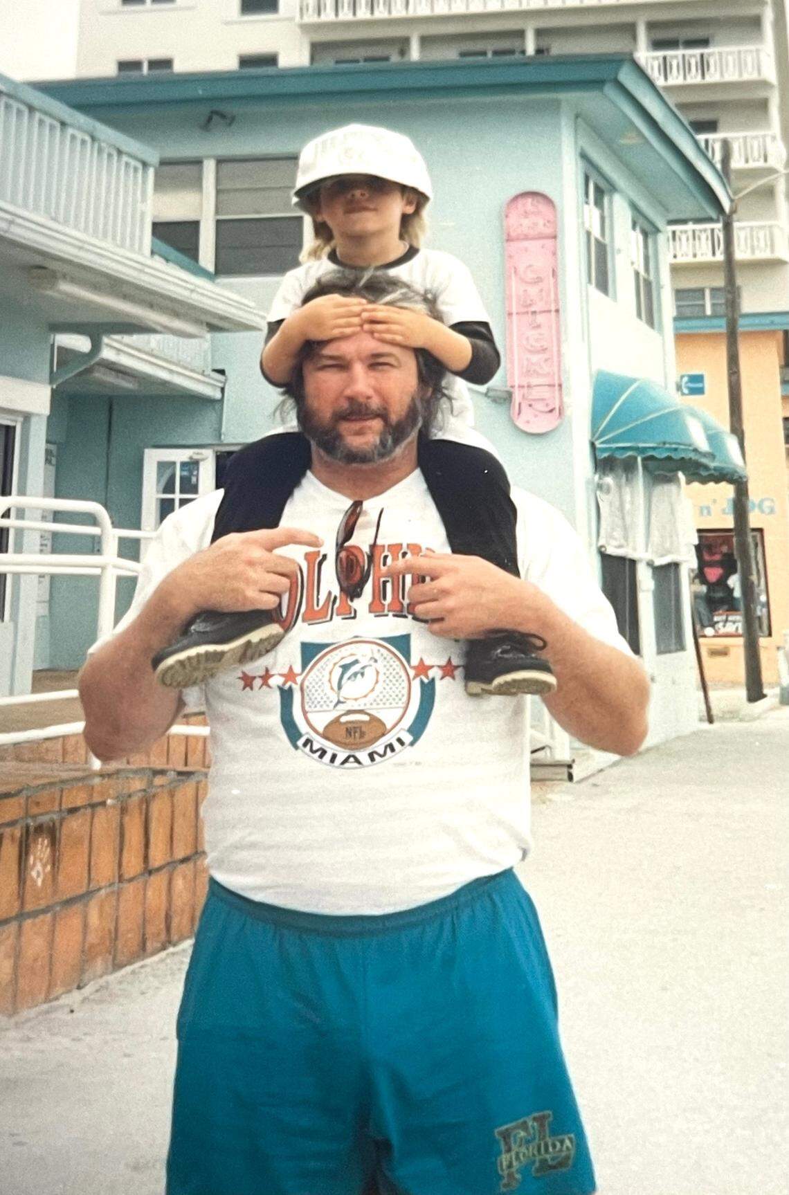 South Florida resident David Zarco has gone viral on TikTok for recreating the recipes of his roommate’s deceased uncle Greg. In this family photo, Greg carries The Roommate on his shoulders.