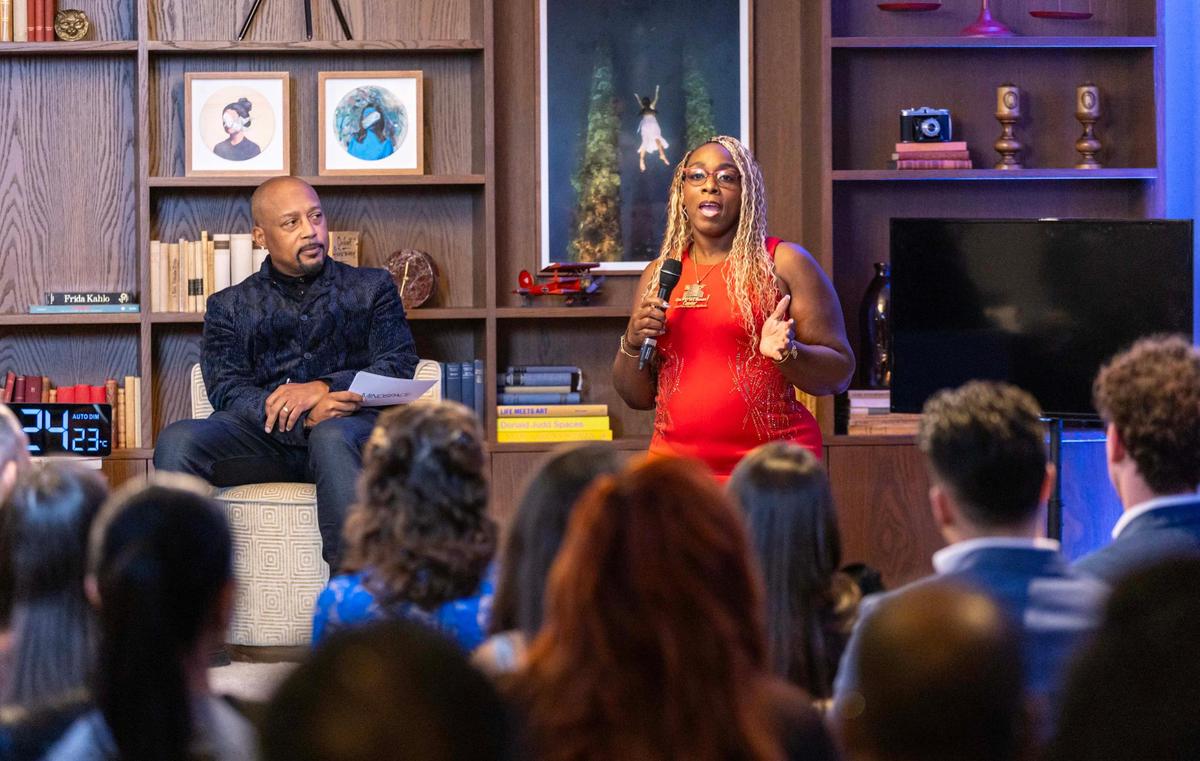 Daymond John, left, listens as Barbara Parker, owner of BF Employment Center, speaks to the audience during “The Big Pitch Night” event at Mindspace Miami on Tuesday, Nov. 19, 2024, in Miami.