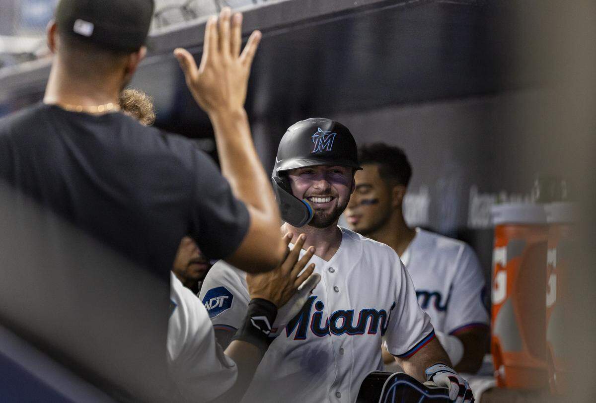Miami Marlins catcher Liam Hicks (34) celebrates in the dugout with teammates after hitting a home run against the Baltimore Orioles in the first inning of their MLB game at loanDepot park on Thursday, May 7, 2026, in Miami, Fla.