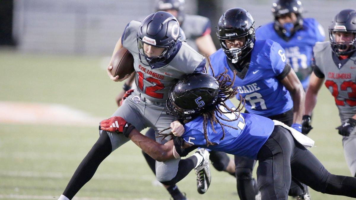Columbus Explorers quarterback Jason Barket (12) is tackled by South Dade Buccaneers defensive back Tedrick Lee (5) during football game on Saturday, September 28, 2024 at Harris Field Park in Homestead. Andrew Uloza / for Miami Herald